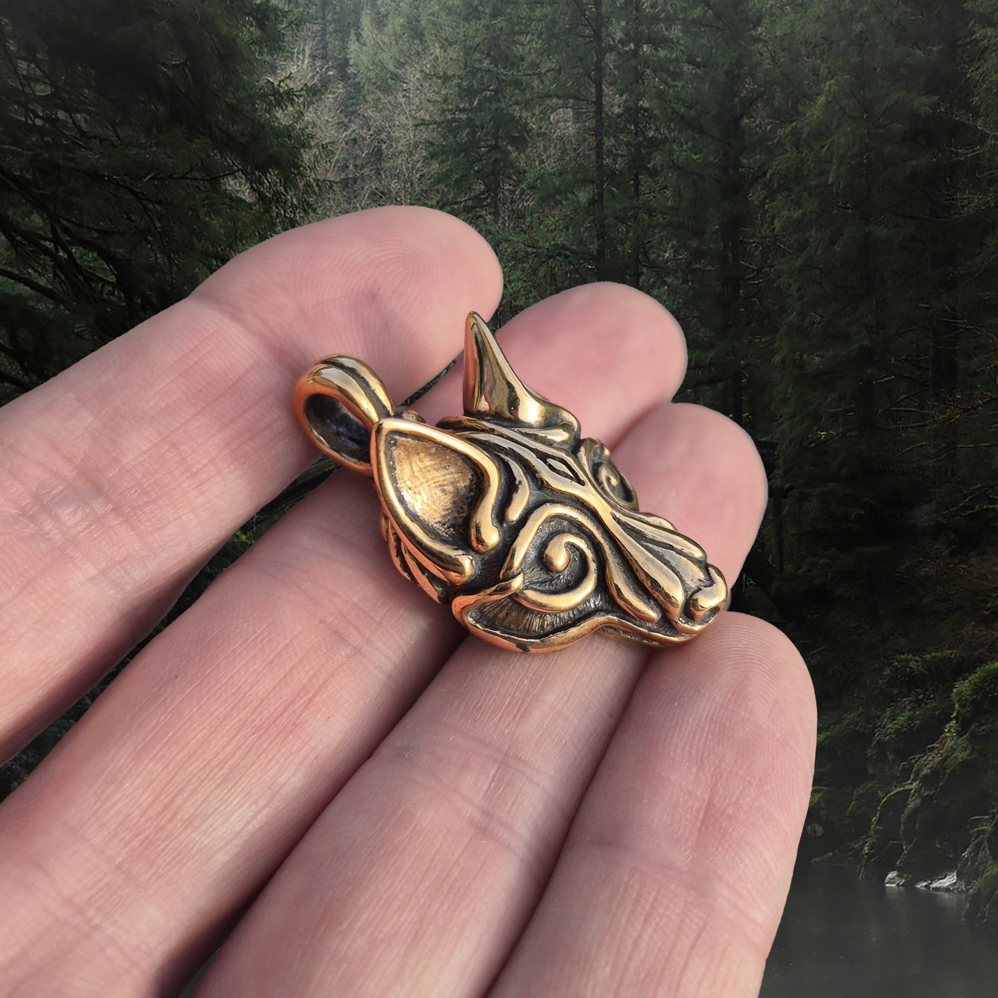 Bronze Borre Style Viking Wolf Head Pendant on Hand - Angle View