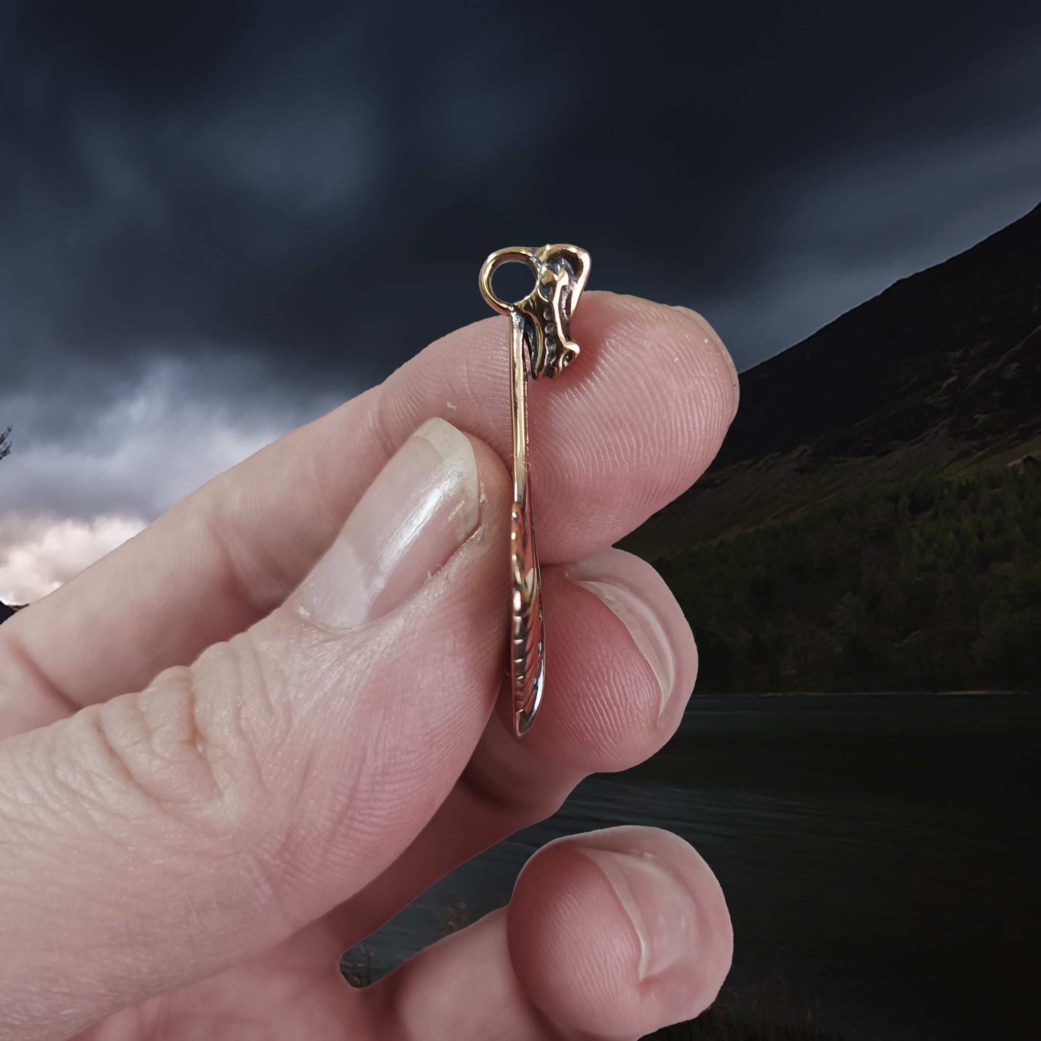 Oseberg Bronze Viking Ship Pendant in Fingers - Side View