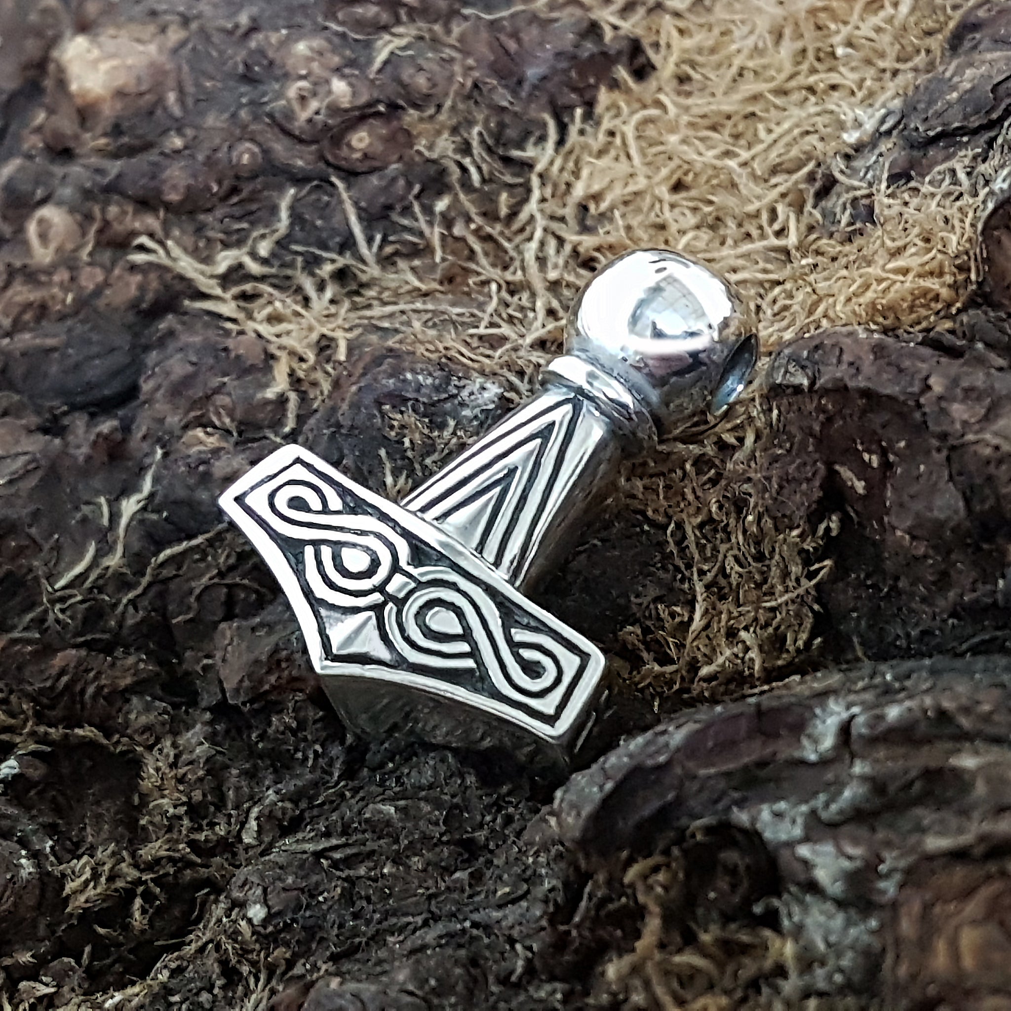 Silver Runic Thor's Hammer on Background - Viking Jewelry