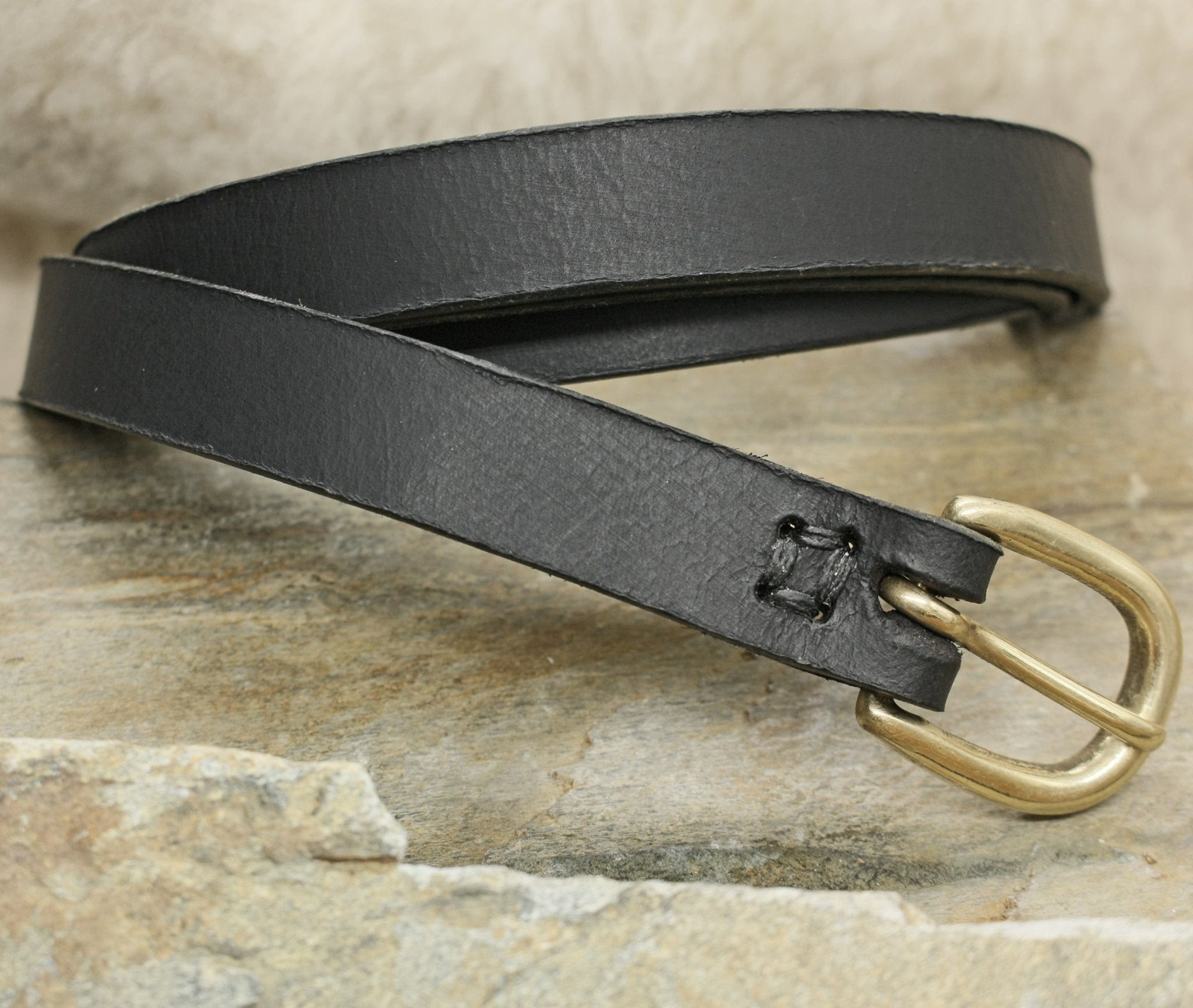 Black 19mm Wide Leather Viking Belt with Brass Buckle on Rock