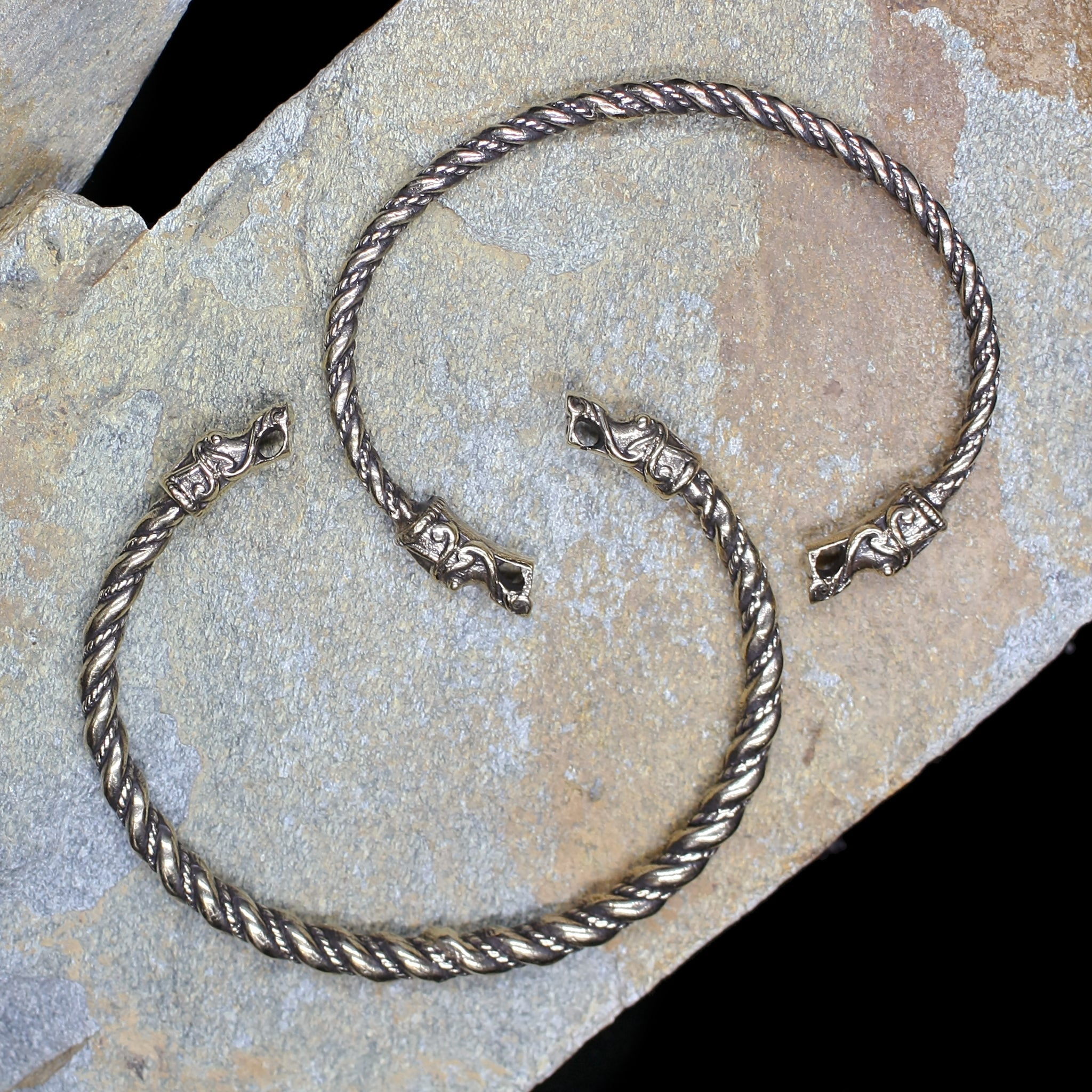 Twisted Bronze Bracelets With Gotlandic Dragon Heads on Rock