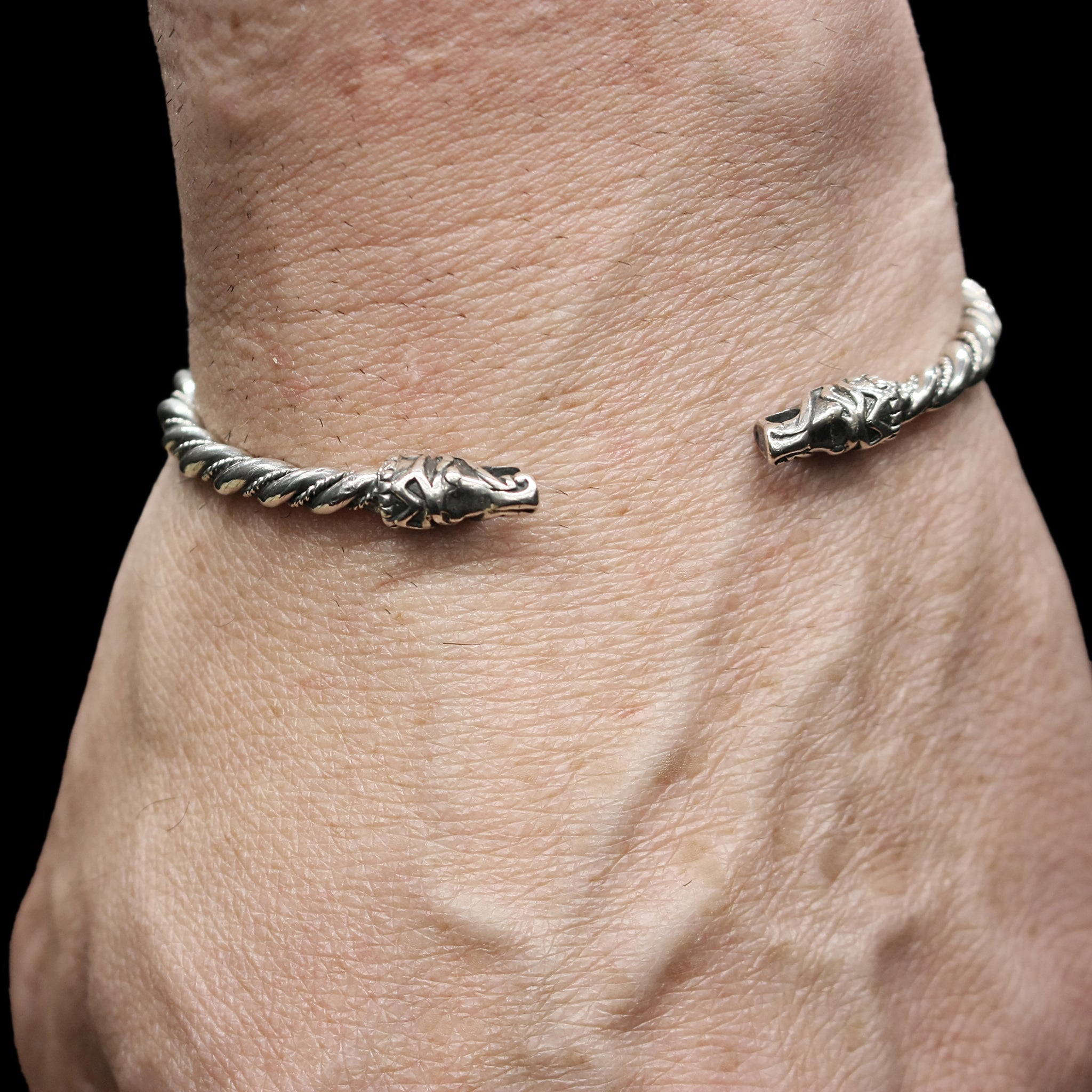 Slim Twisted Silver Bracelet With Gotlandic Dragon Heads On Wrist