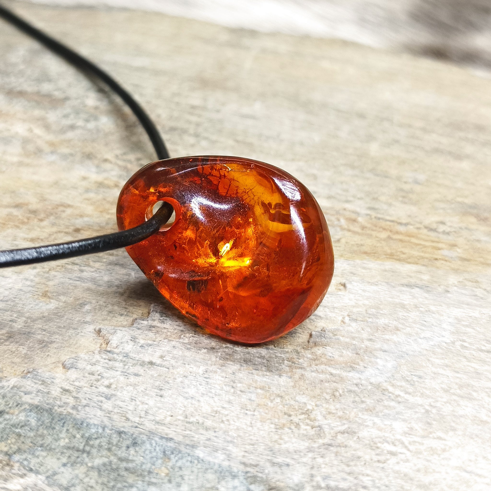 Amber Amulet Pendant on Rock with Leather Thong on Side