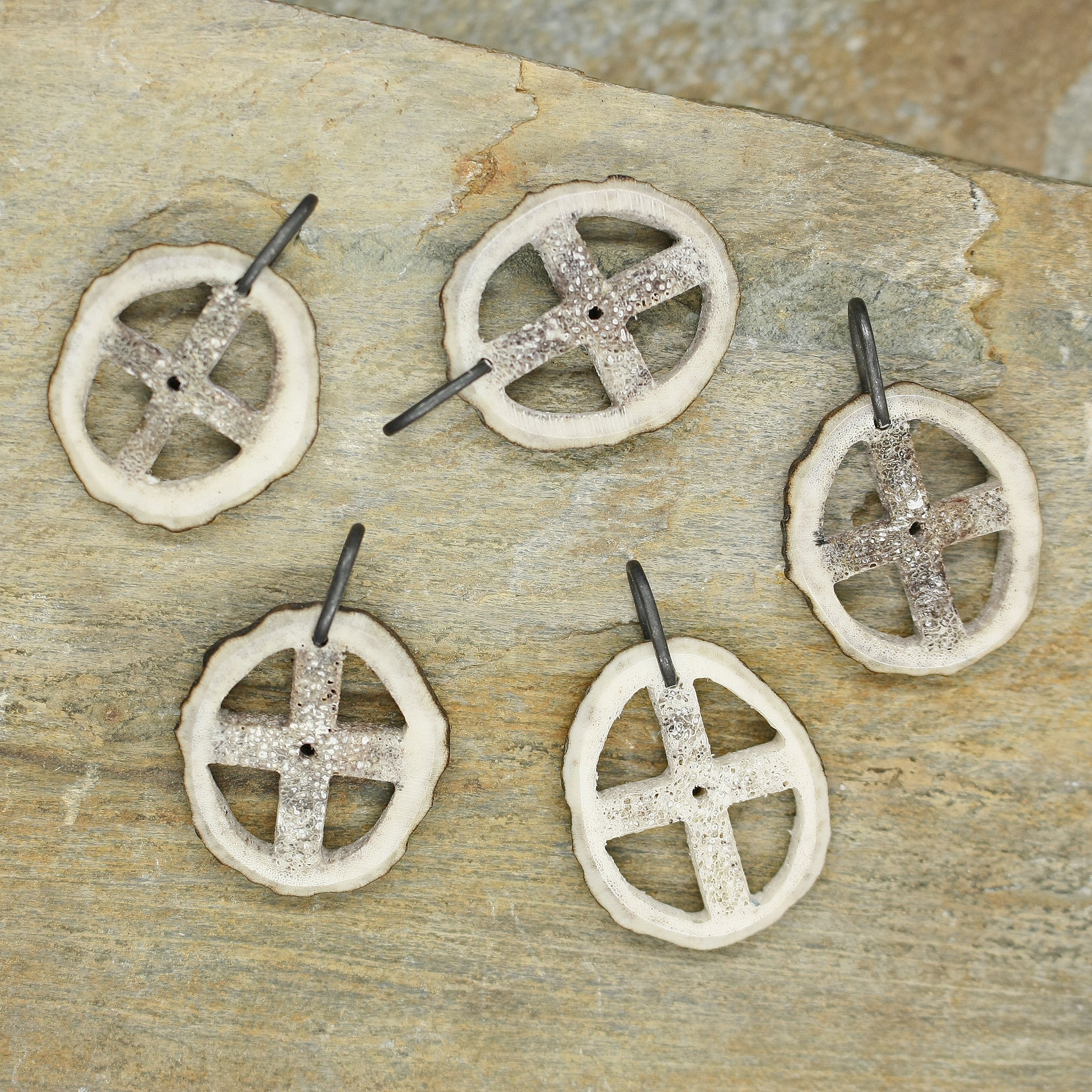 Antler Sun Cross Odin Pendants on Rock