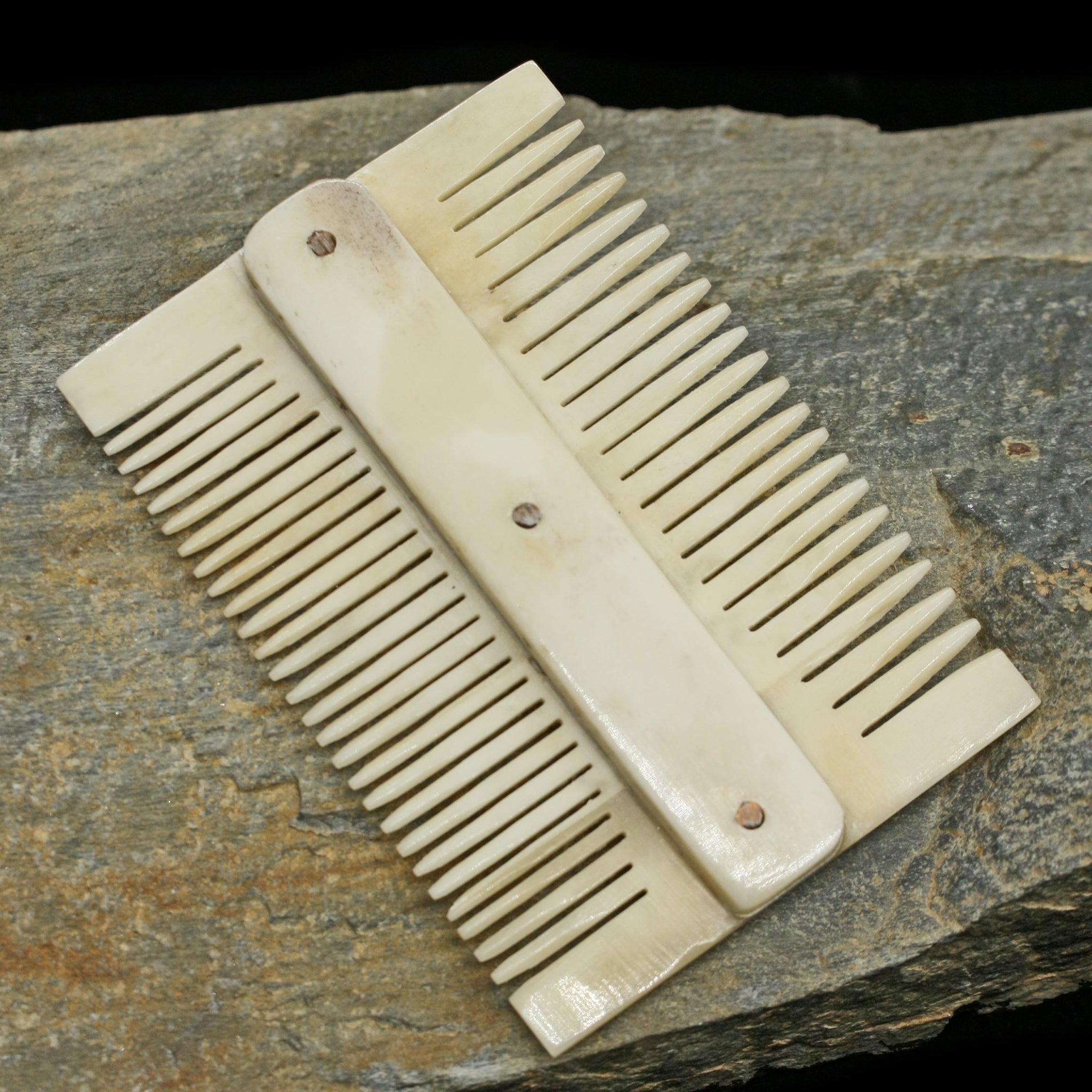 Double Sided Bone Viking Comb on Rock