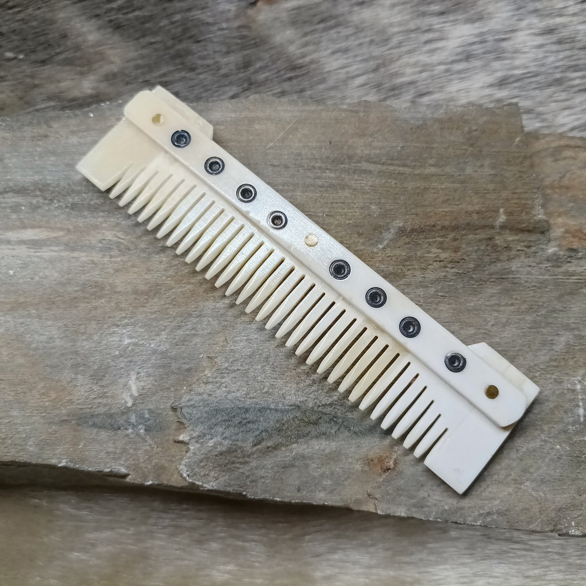 Medium Decorated Bone Viking Comb on Rock