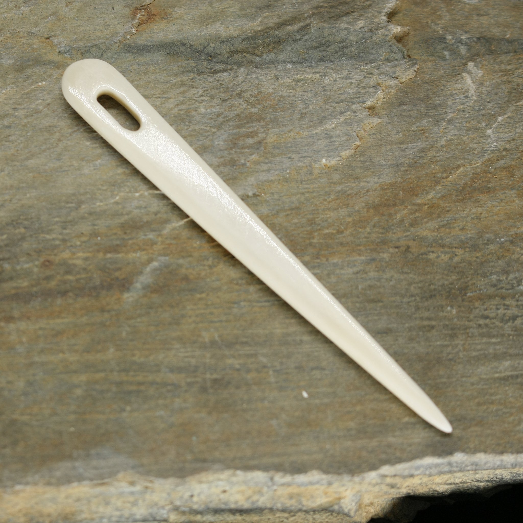 Handmade Bone Nalbinding Needle on Rock