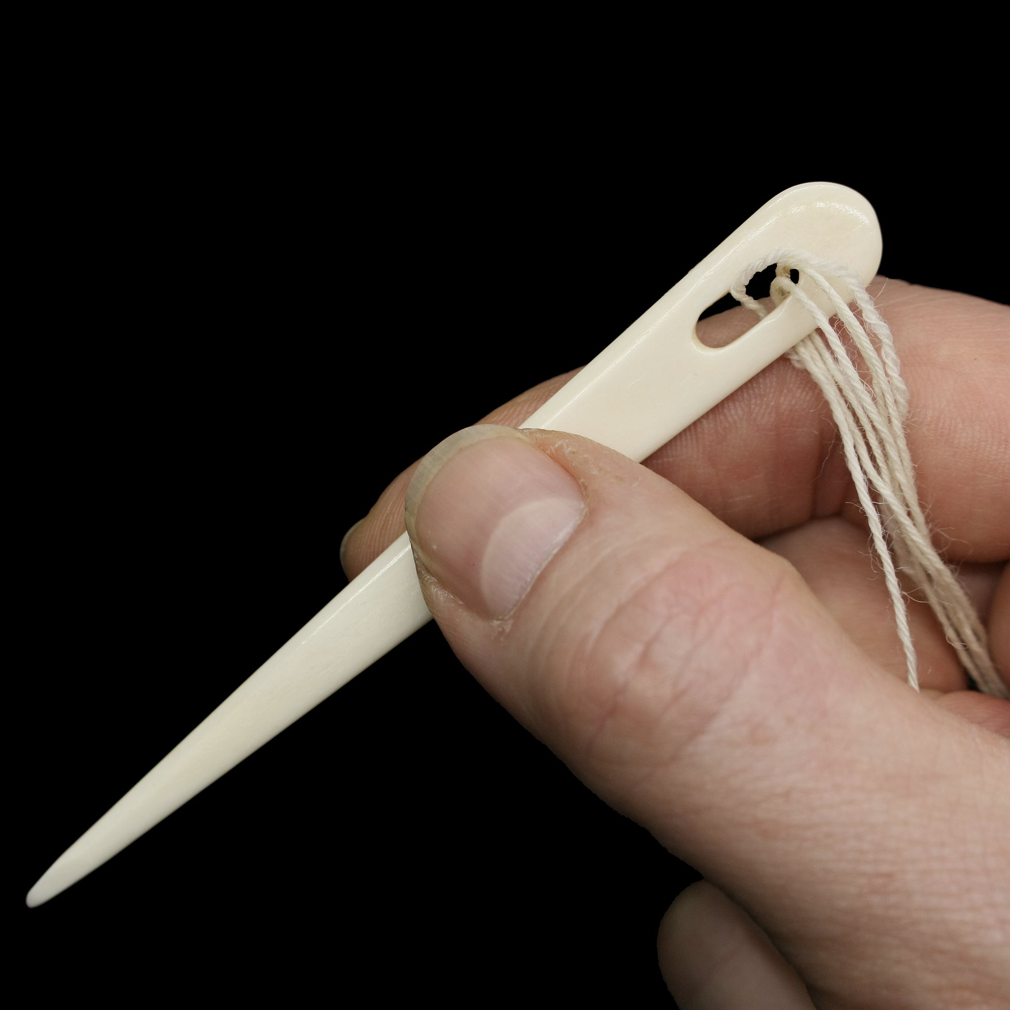 Handmade Bone Nalbinding Needle with Wool in Hand