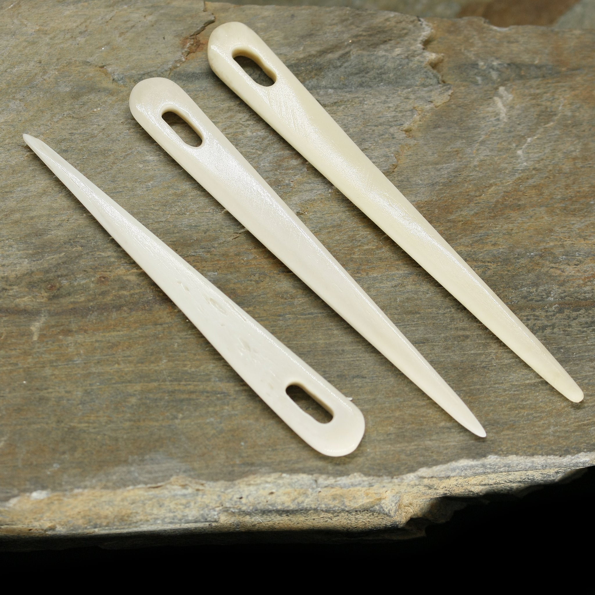 Handmade Bone Nalbinding Needles on Rock