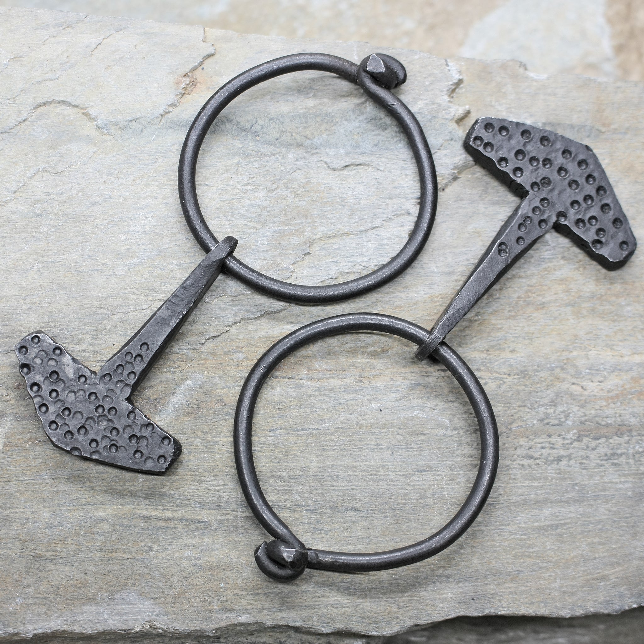 Embossed Iron Thors Hammer Replica Pendants on Rings on Rock
