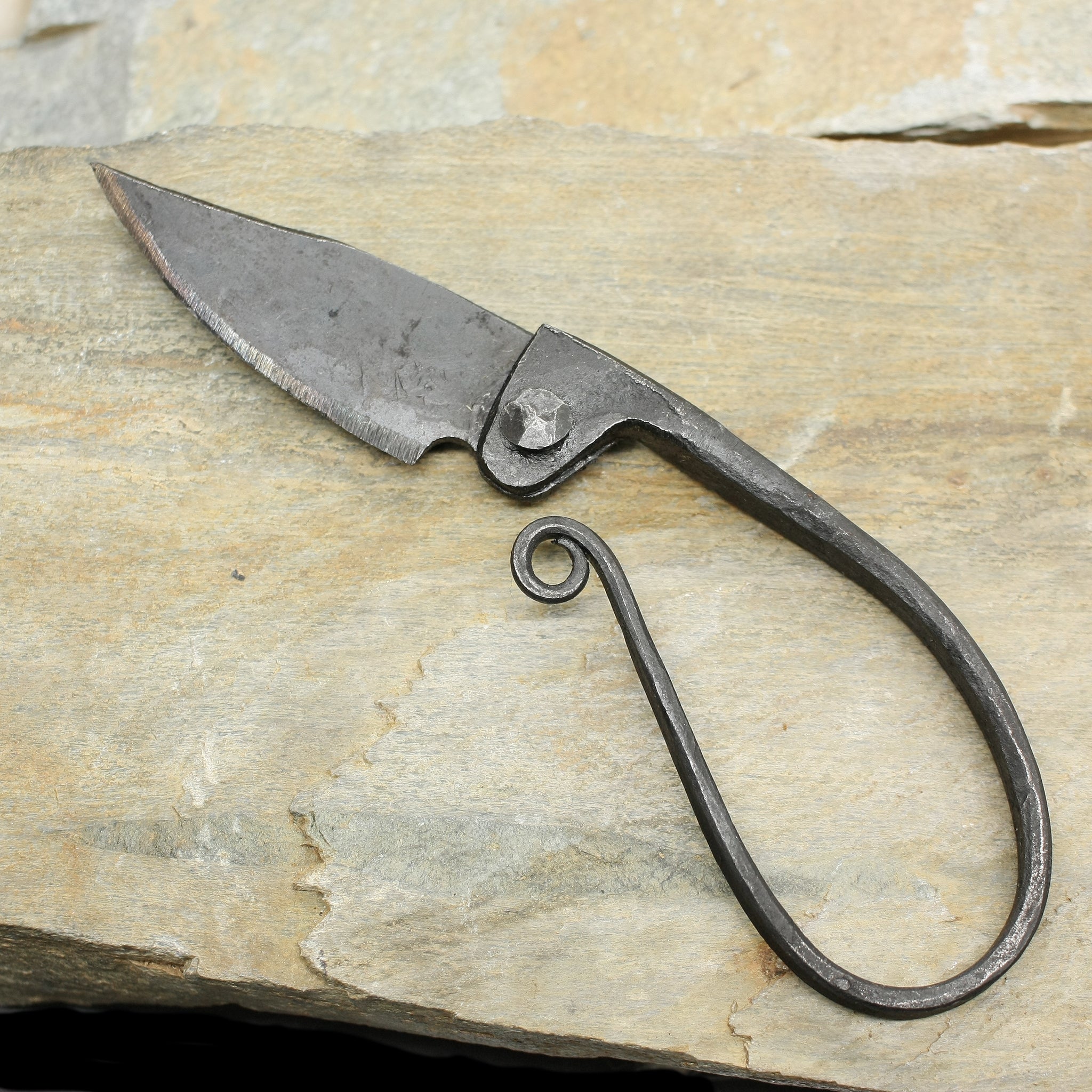 Woman's Folding Replica Viking Knife on Rock