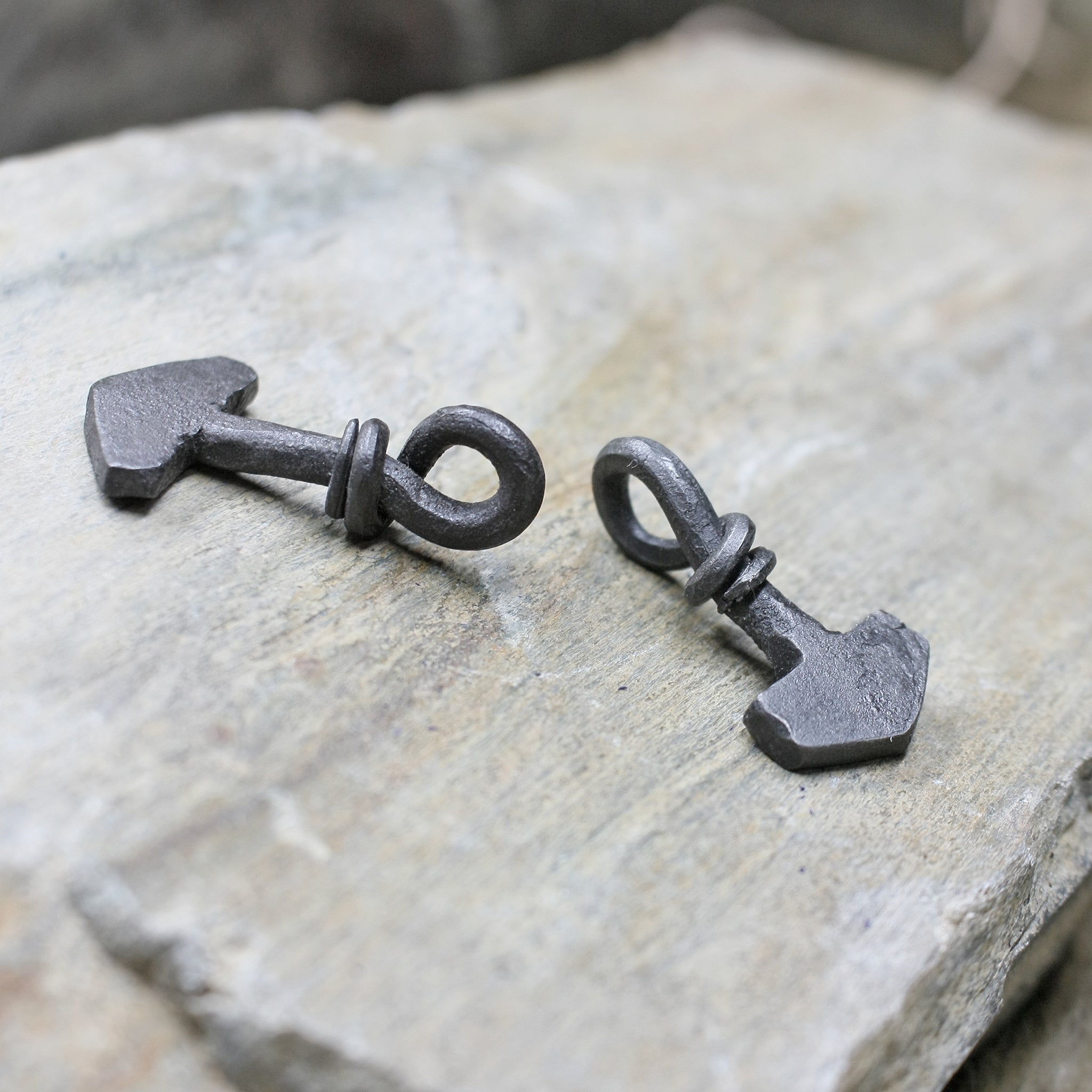 Small Iron Thors Hammer Pendants on Rock - Side View