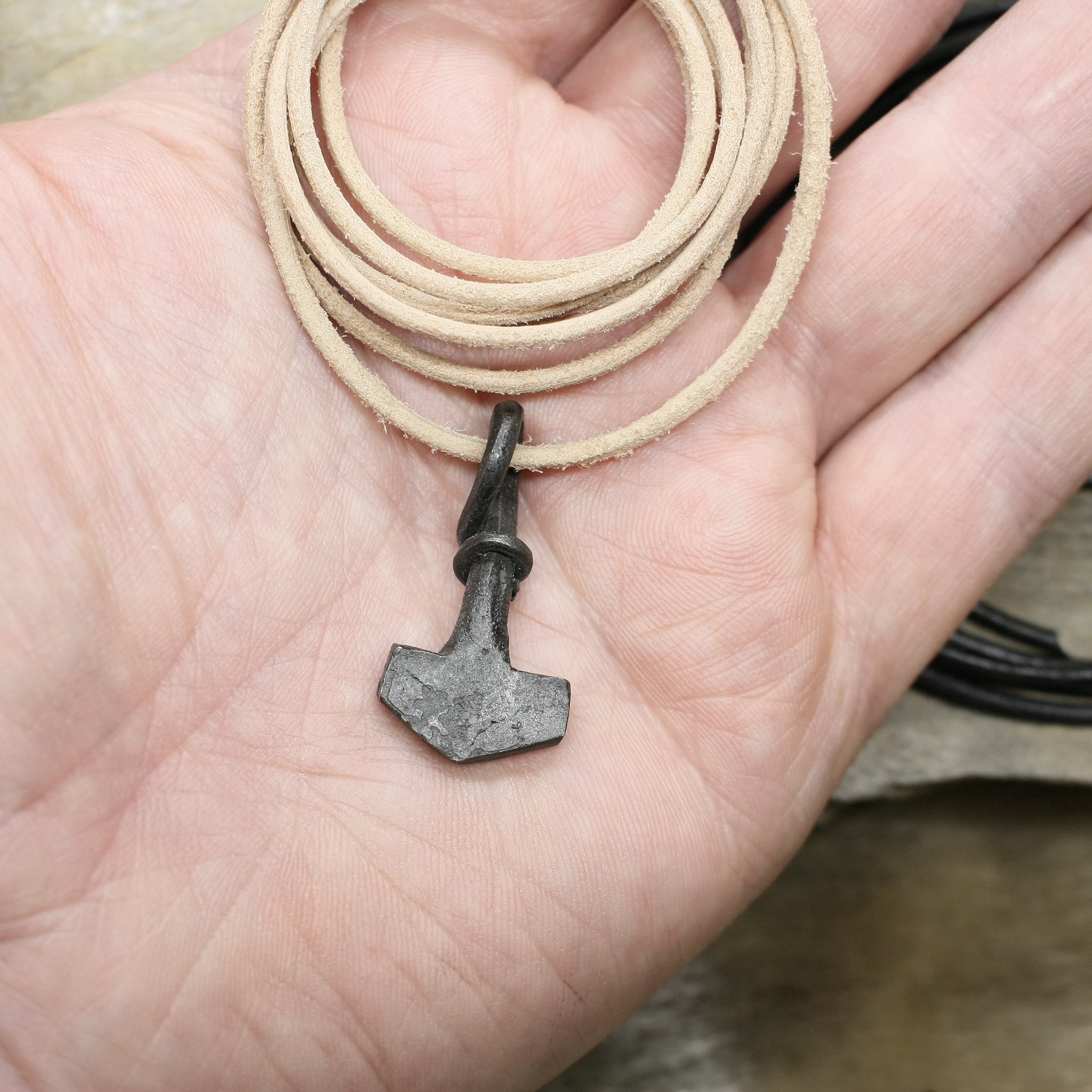 Small Iron Thors Hammer Pendant on Thong on Hand