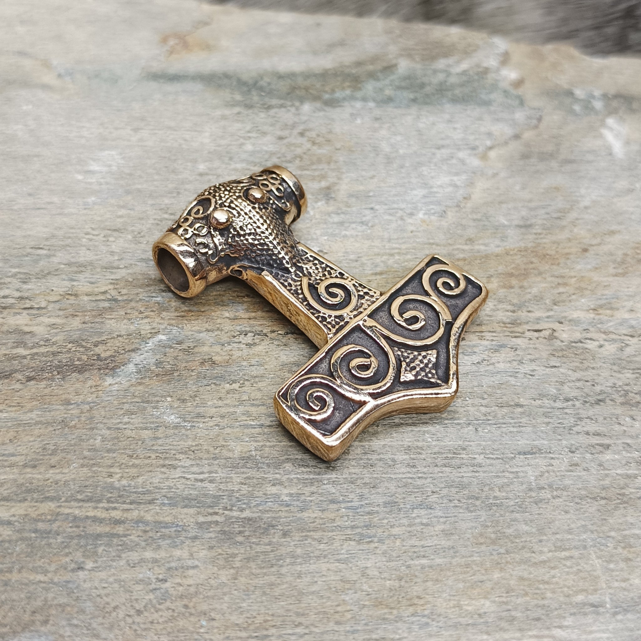 Bronze Filigree Thors Hammer Pendant From Kabara on Rock - Front Angle View