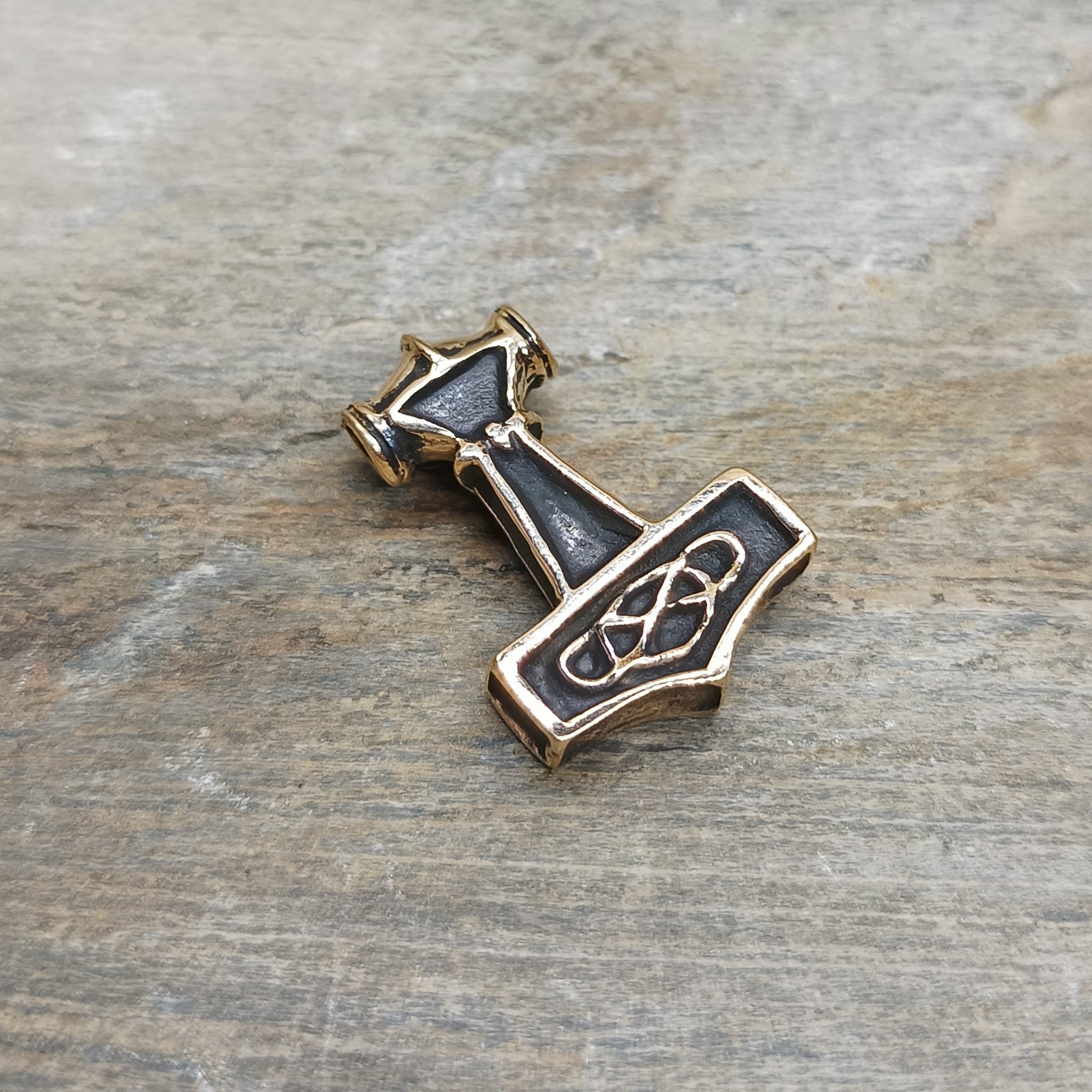 Small Bronze Thunder Thors Hammer Pendant on Rock - Back Angle View
