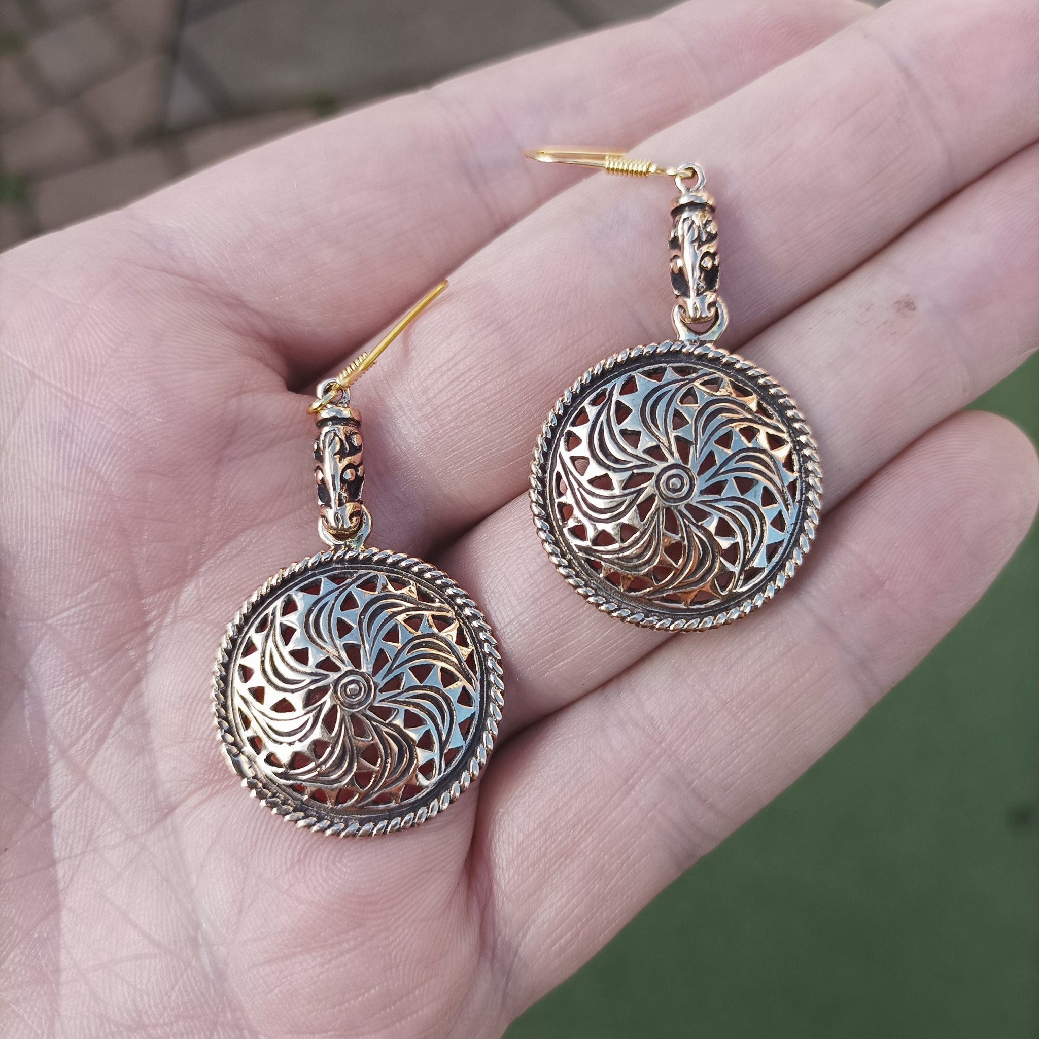 Bronze Gotland Sun Wheel Earrings in Hand