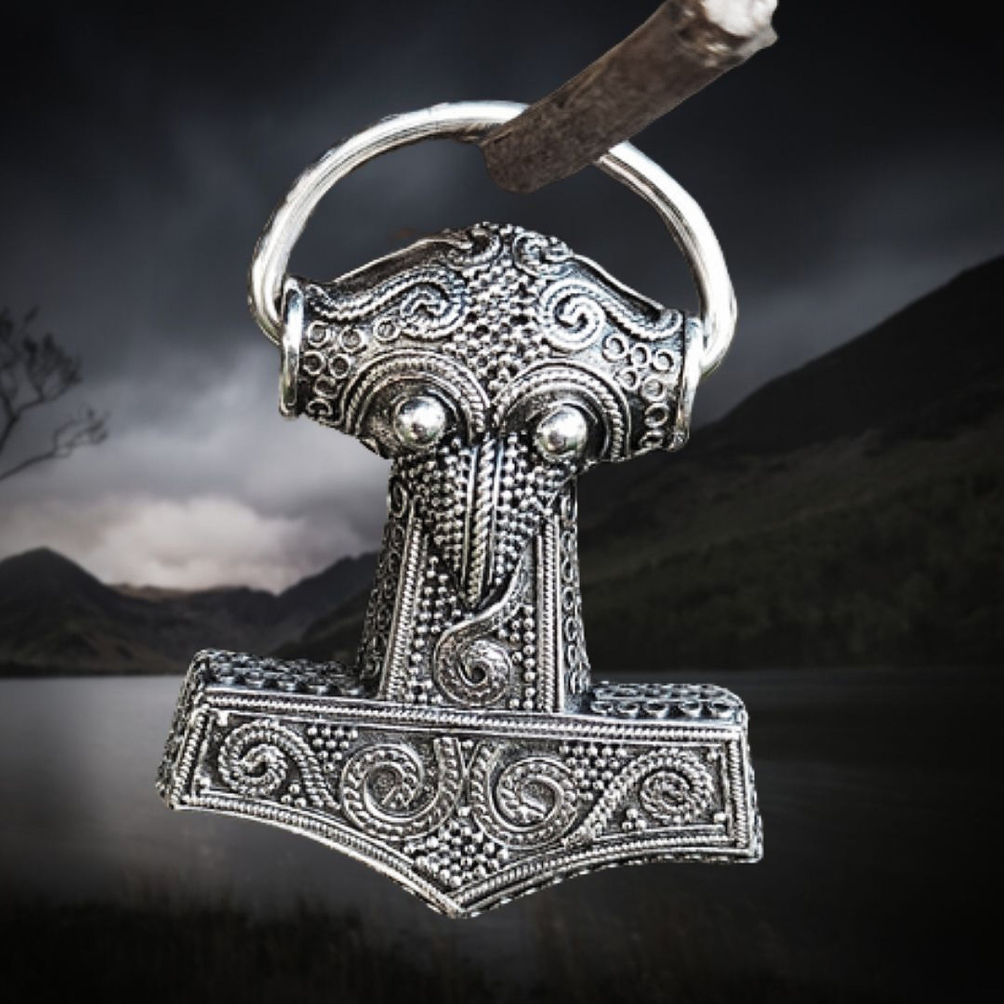 Silver Filigree Thors Hammer Pendant Replica from Kabara on Dark Lake Background