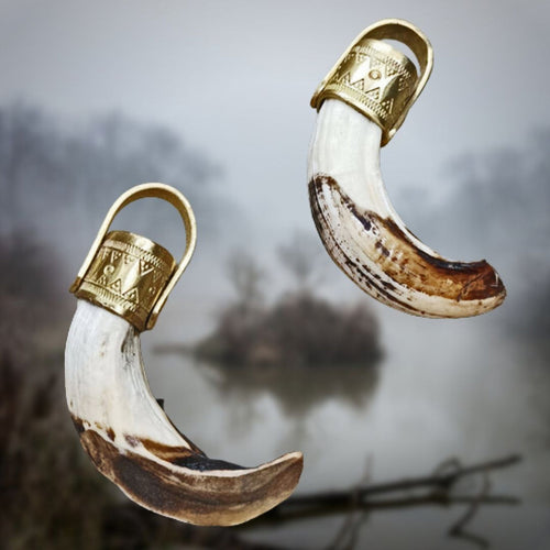 Large Boar Tusk Pendants on Foggy Background